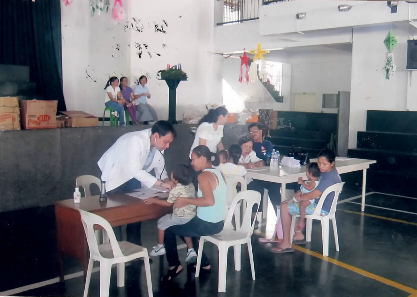 Sacred Heart physician providing care to a family during outreach