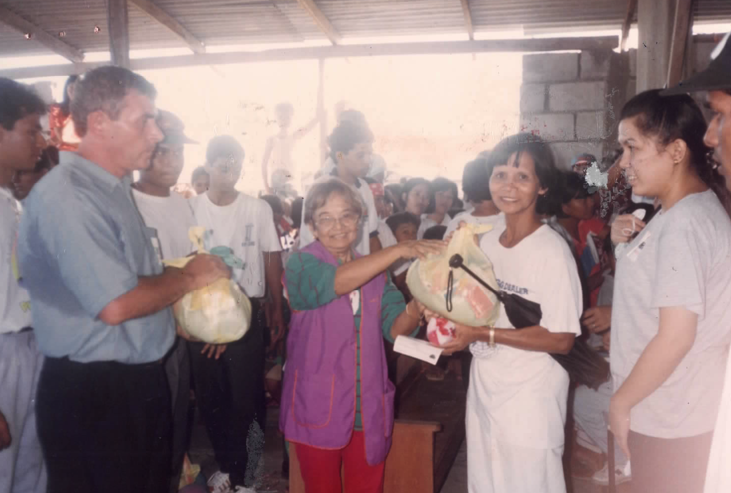 Mission volunteers distributing relief goods during a community outreach activity